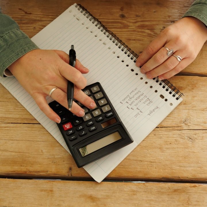 Kosten Alltagsbegleitung Halle/Saale - Berechnung der Betreuungskosten für Seniorenbetreuung mit Stift, Notizblock und Taschenrechner.